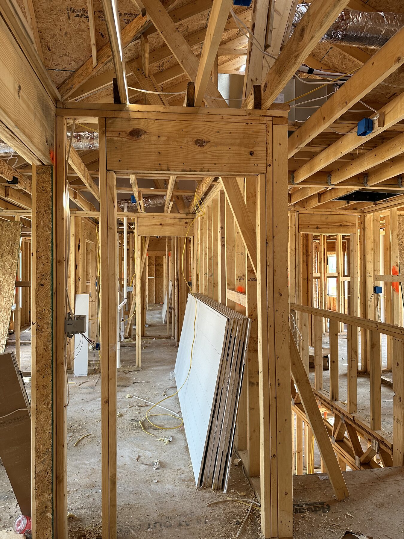 Interior framing of a unit under construction, showing window installation